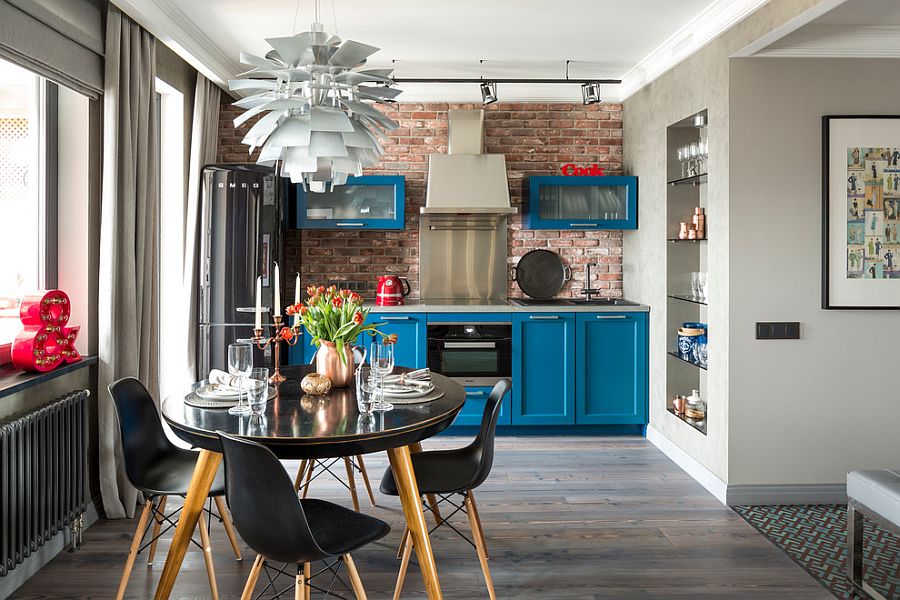 Lovely blue cabinets and bold black refrigerator enliven the industrial kitchen