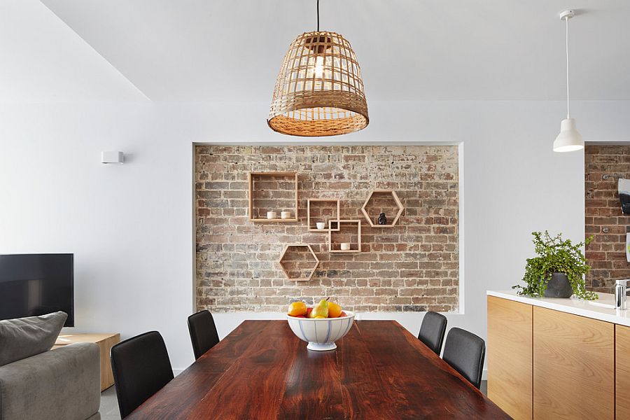 Lovely recessed brick wall in the dining room with geometric wooden shelves [Design: elaine richardson architect]