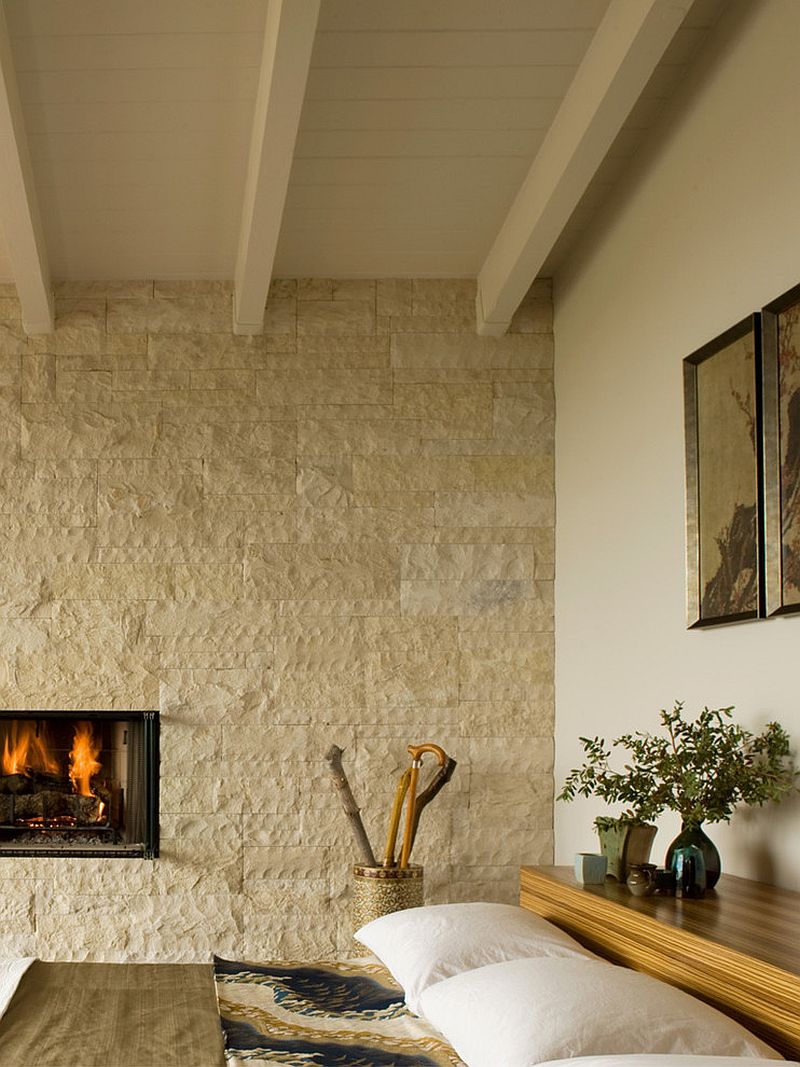 Midcentury bedroom with natural stone backdrop and a platform bed