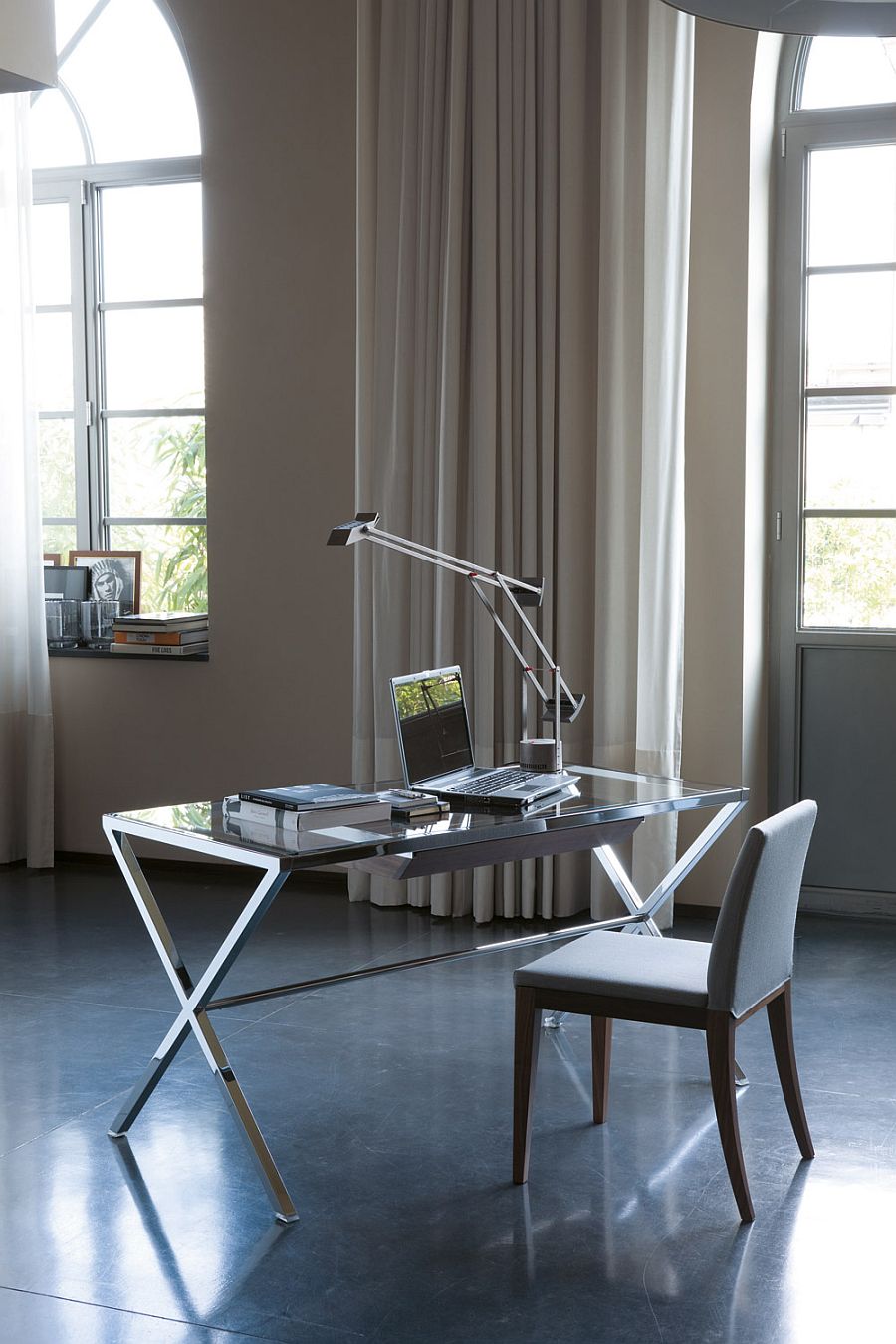 Modern desk with glass top and polished steel frame