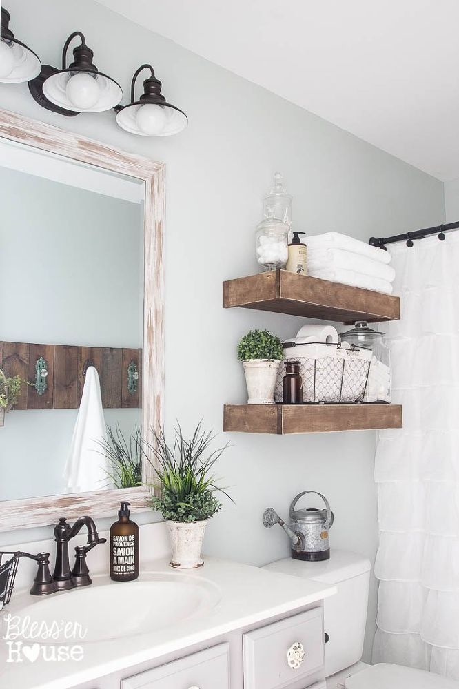 Modern farmhouse bathroom with rustic wood shelving above toilet