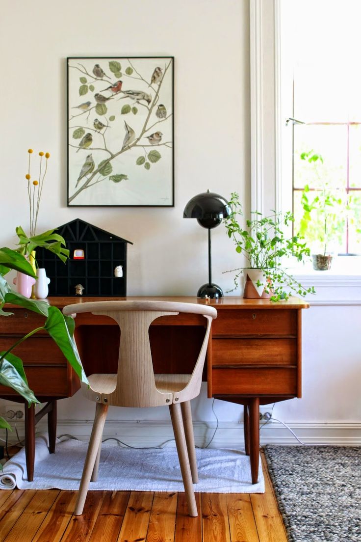 Office space with several plants and plant inspired wall art