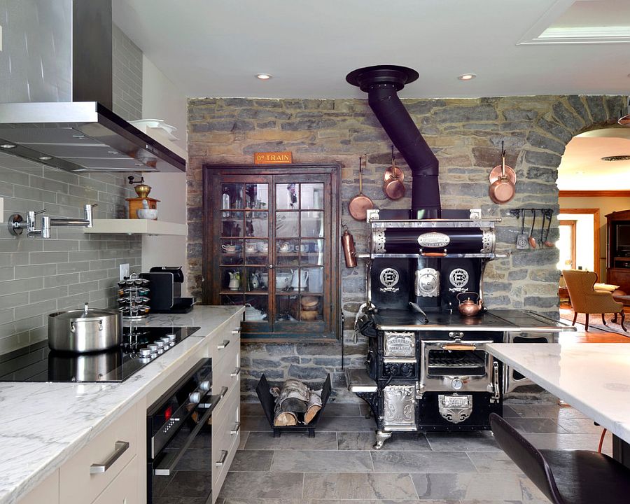 Old world charm brought to modern rustic kitchen with stone wall [Design: Cedarstone Homes Limited]