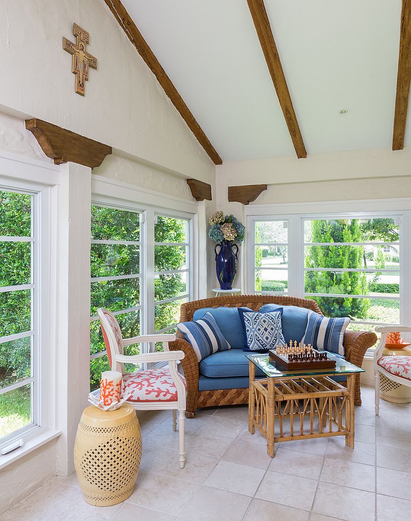 Original wooden beams of the house and custom decor steal the show in the small sunroom [Design: Margaux Interiors]