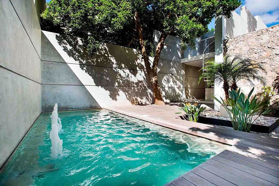 Outdoor private courtyard with pool and a small wooden deck