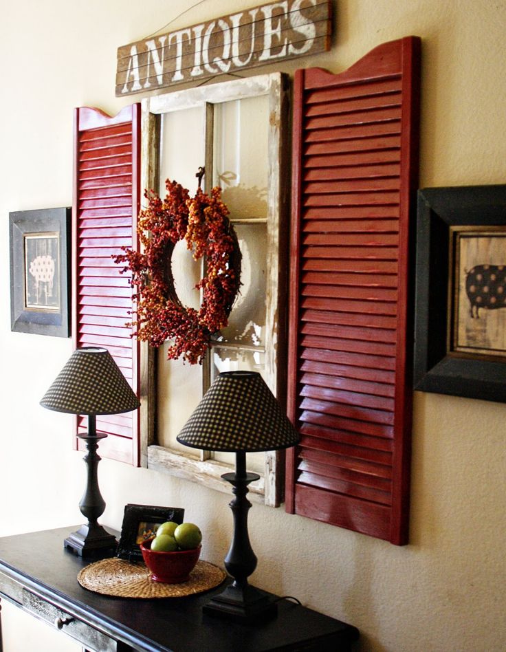 Red shutters and old window used as wall art above a hall table