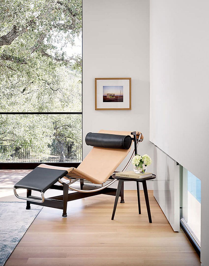 Relaxing lounger and side table create a cozy reading nook in the bedroom