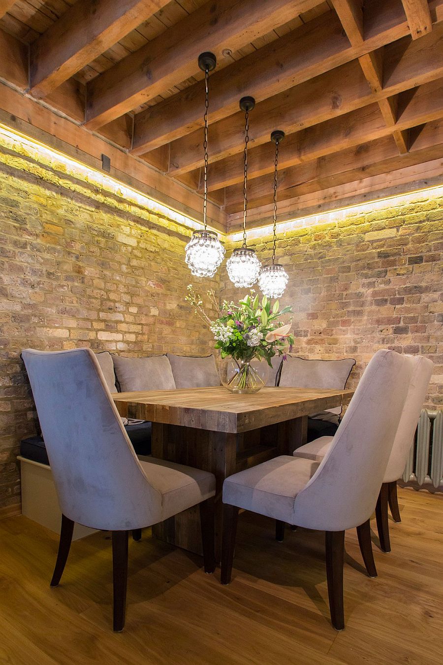 Rustic dining space with brick walls and custom wooden dining table