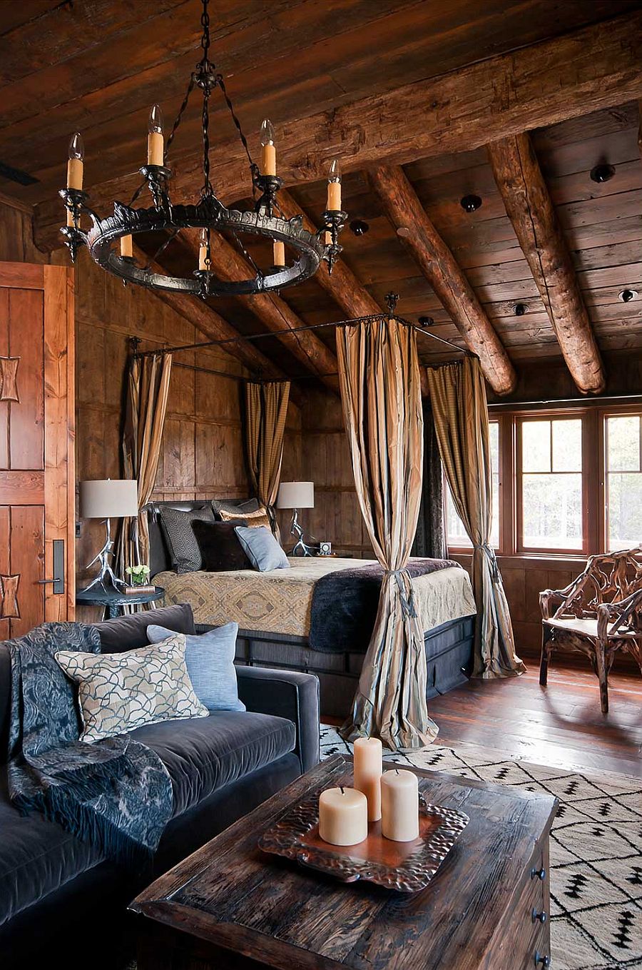 Rustic log cabin bedroom with a cozy canopy bed