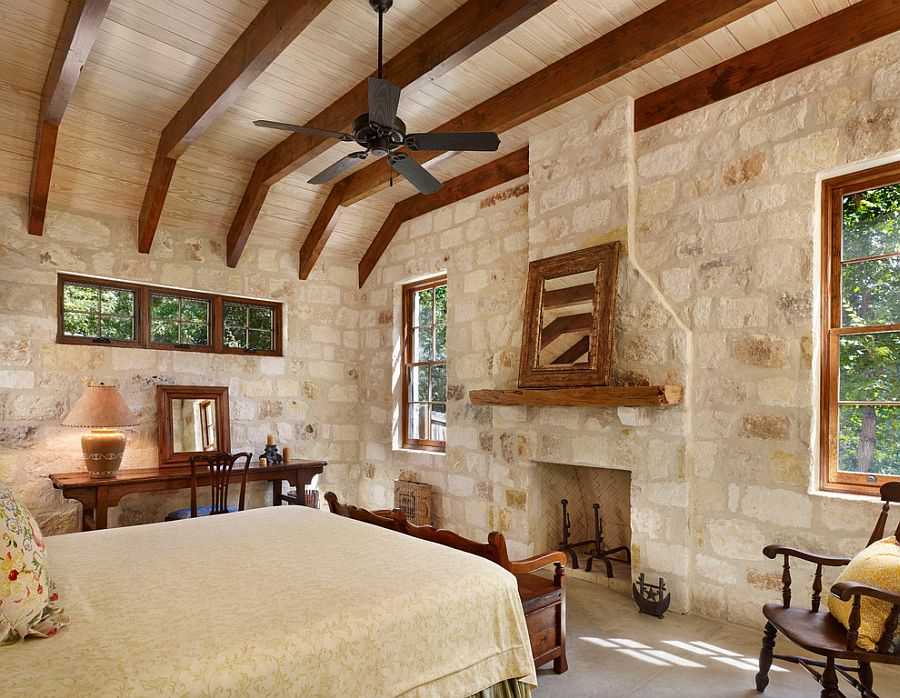 Rustic modern bedroom with exposed wooden beams and stone and mortar wall