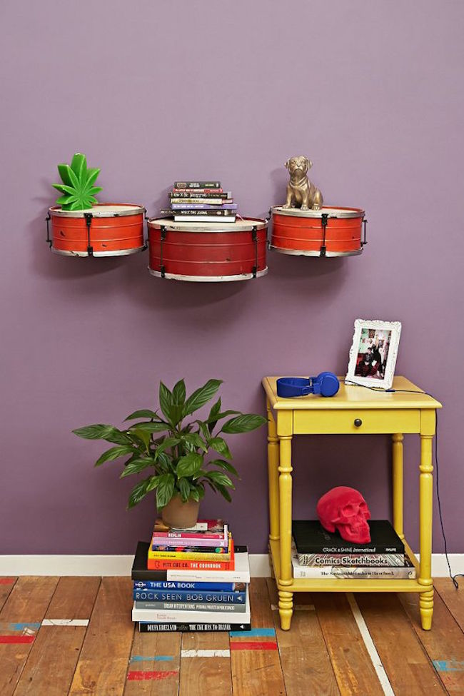 Small drums secured to wall as shelves