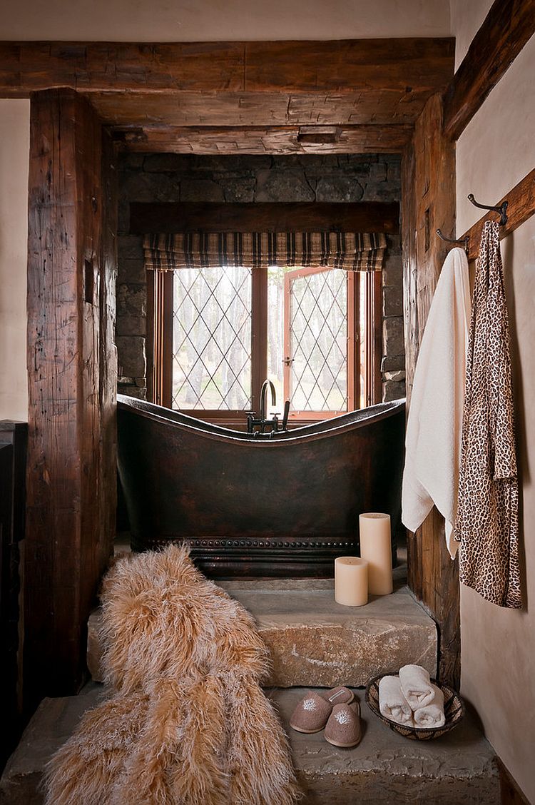 Small rustic bathroom with stone steps and a custom copper bathtub