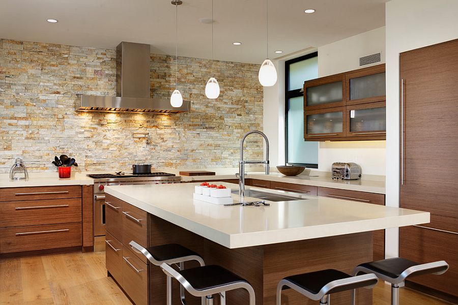 Smart contemporary kitchen with lovely lighting and stone accent wall [From: By Design / Dave Adams Photography]