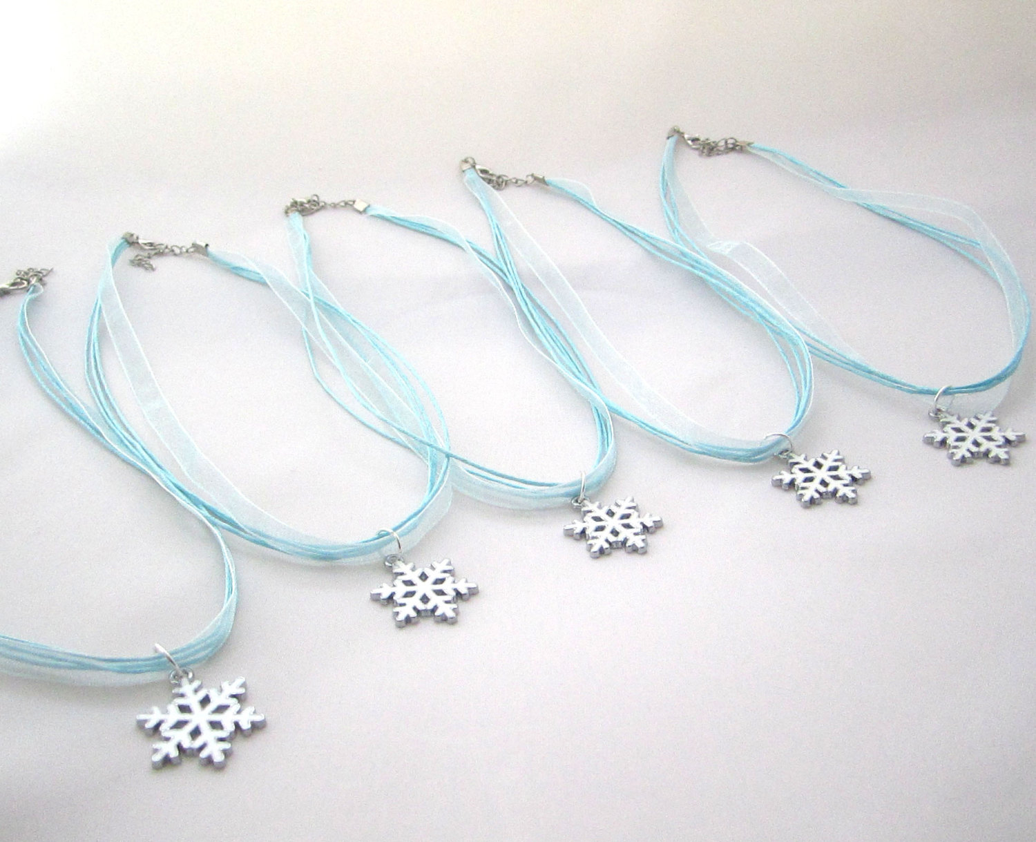 Snowflake charm necklaces from Etsy shop Favor Wrap