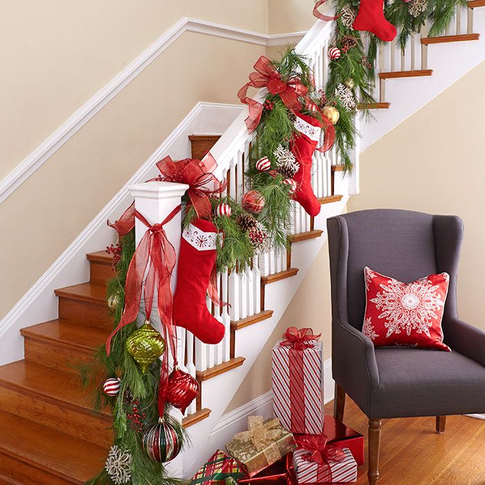 Stockings hung along the stairway banister with garland