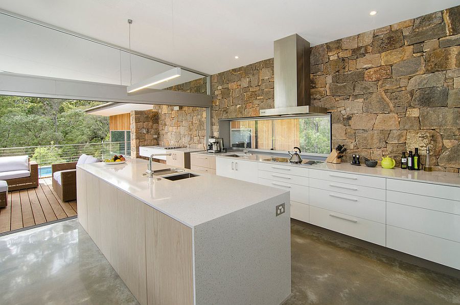 Stone Wall Connects The Kitchen With The Pool Deck Outside 