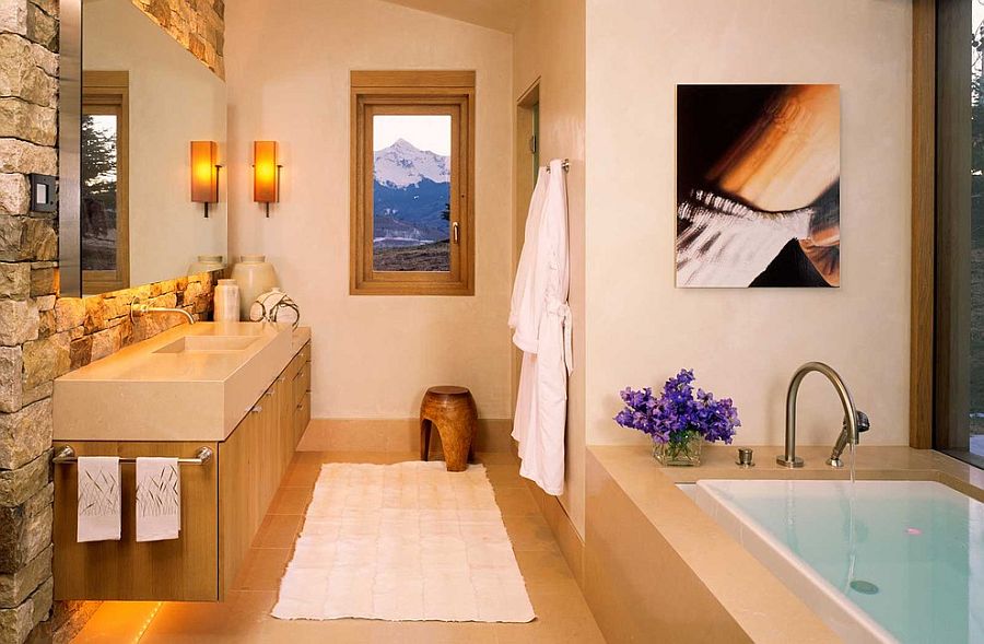 Stone wall in the bathroom brings cabin style to the modern setting