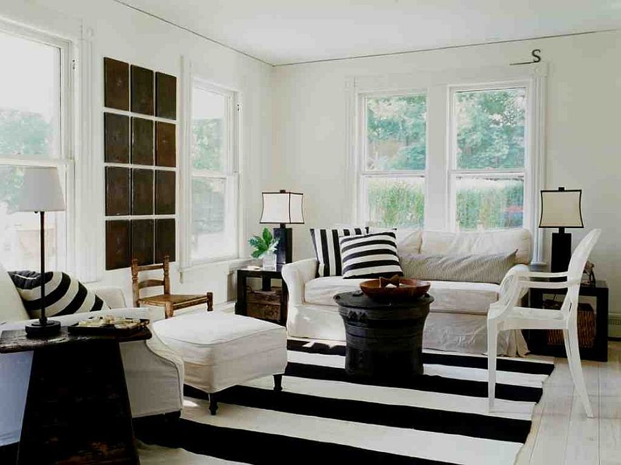 Striped rug, black coffee table and accent pillows for the shabby chic living room [Design: SchappacherWhite Architecture]