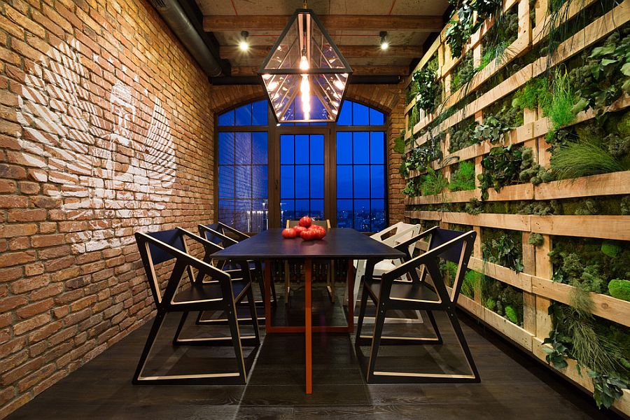 Stunning dining room with green wall on one side and a brick wall on the other! [Design: MARTIN architects]