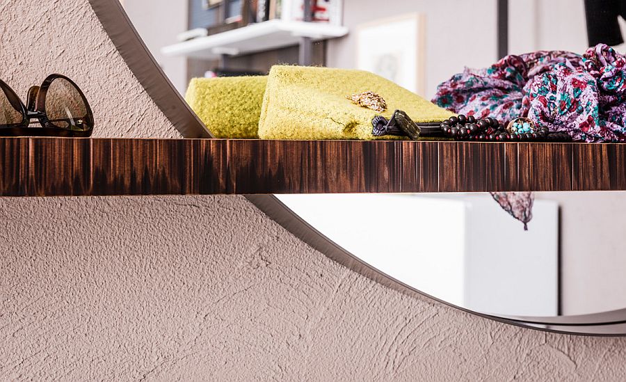 Stylish combination of floating shelf and round mirror