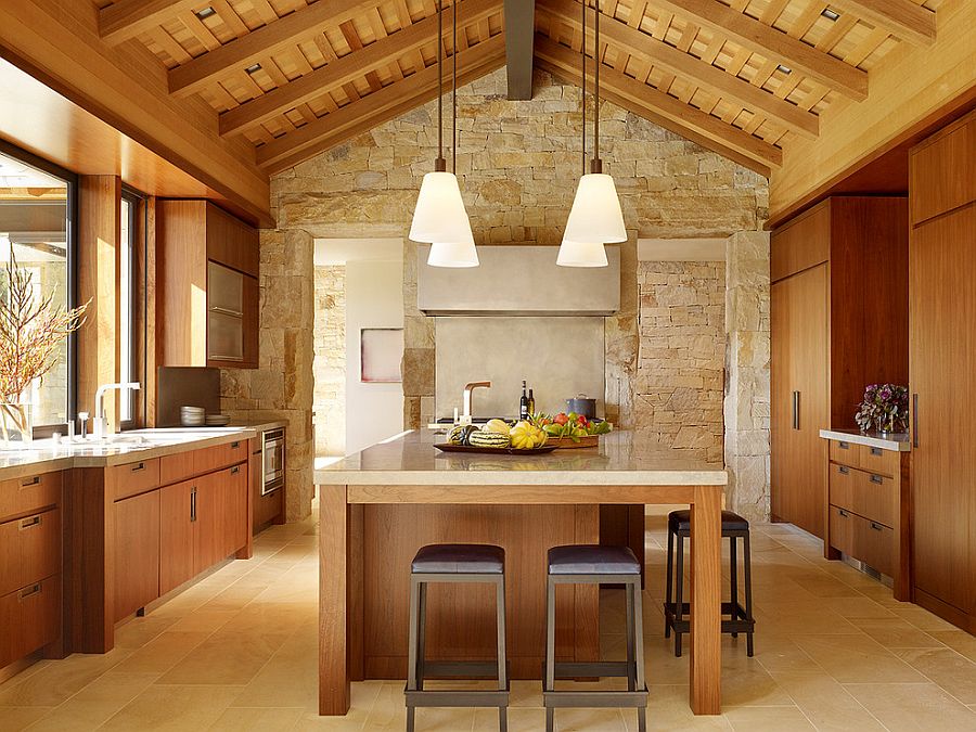 Textured limestone wall gives this kitchen a relaxed, farmhouse vibe [Design: Walker Warner Architects]