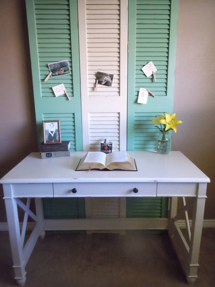 Three shutters used as a bulletin board in front of a desk