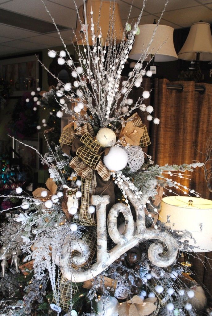 Twigs, burlap, styrofoam balls, and ribbon combined in a detailed tree topper