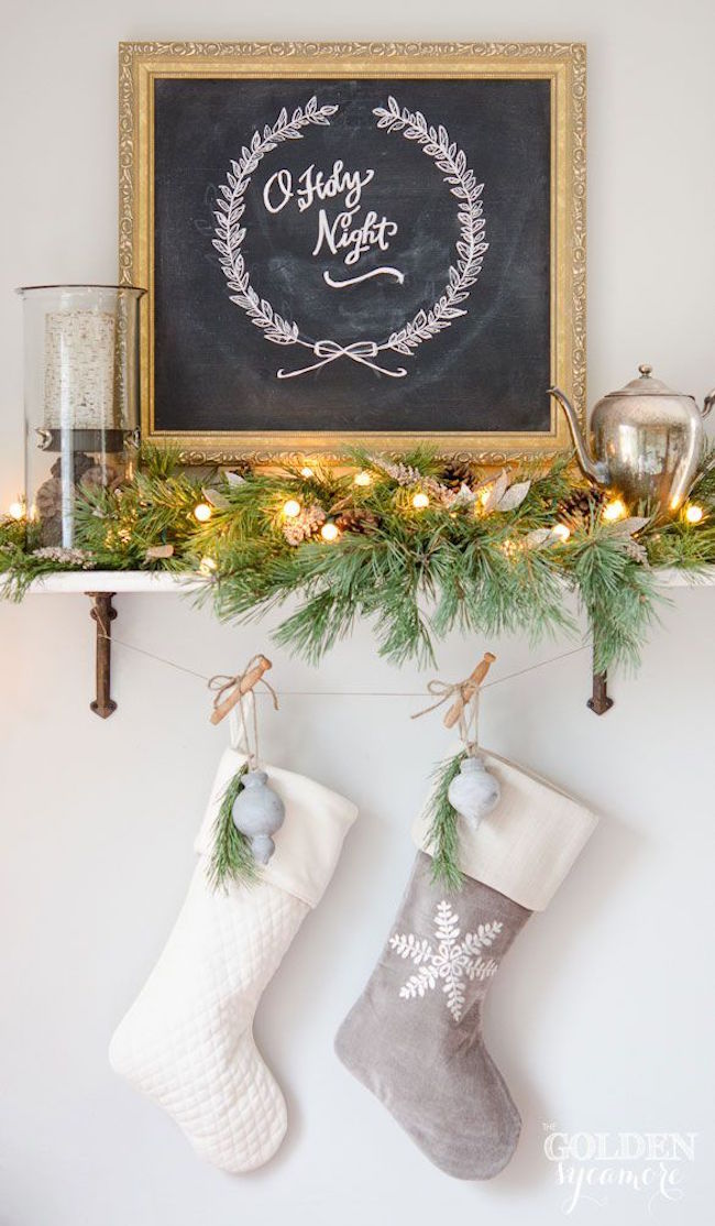 Two stockings hung on a shelf with some clothing pins