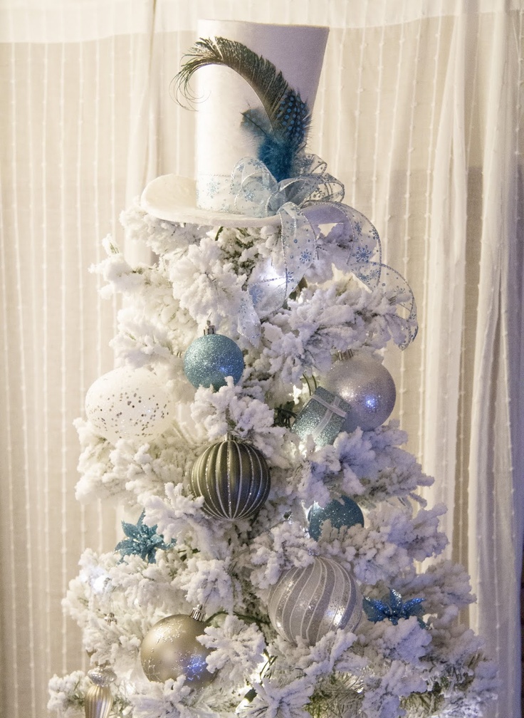 White top hot with feather that matches a white tree