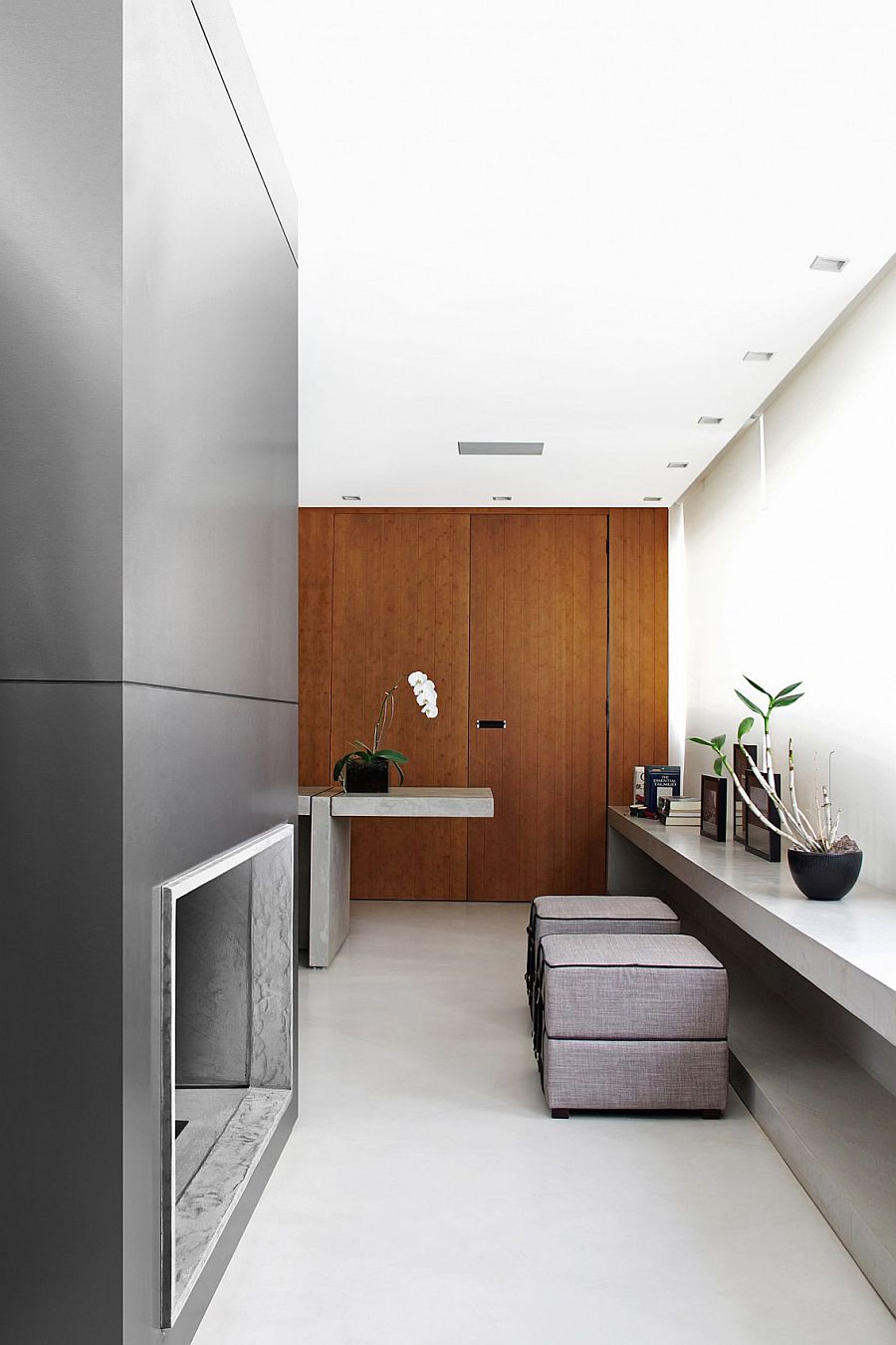 Wooden doors and wall surfaces bring warmth to the modern minimal home