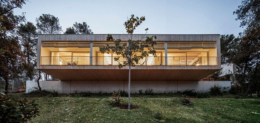 Wooden structure and beautiful lighting turn the home into an inviting hub