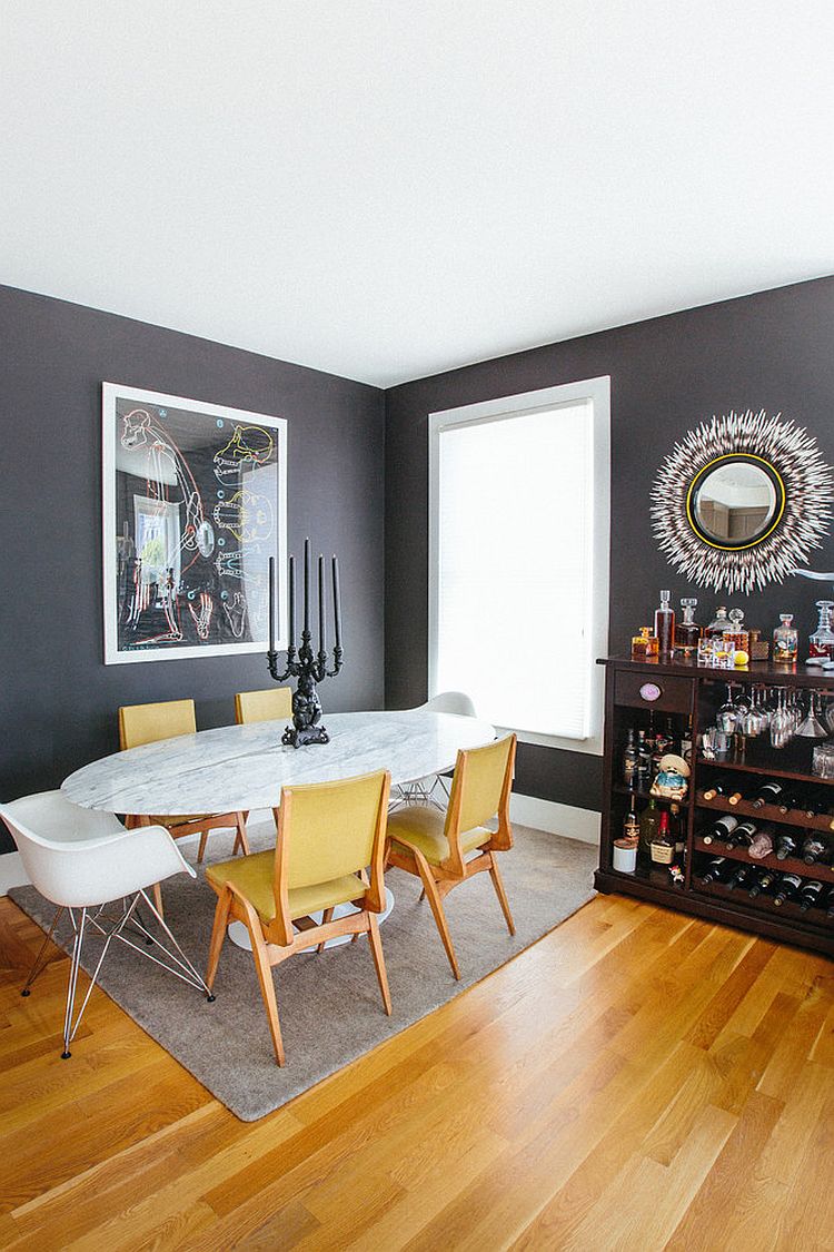 Yellow chairs add a bright accent hue to the dining room in white and gray