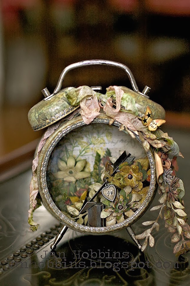 Altered alarm clock with flowers and an arrow inside
