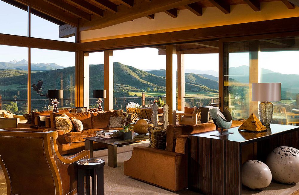 Amazing mountain views become a part of the open living room design with glass walls