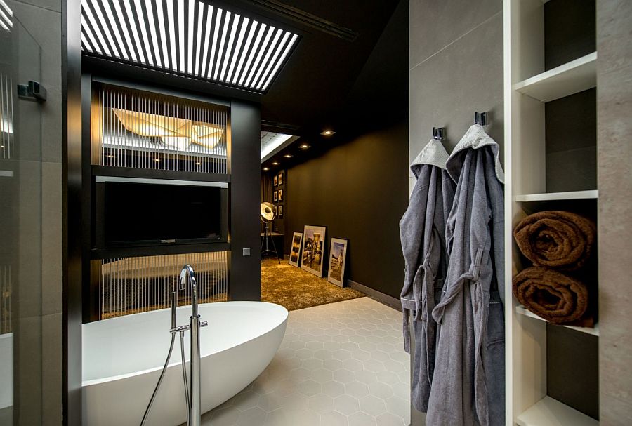 Bathroom allows you to enjoy your favorite tele shows as you take a dip