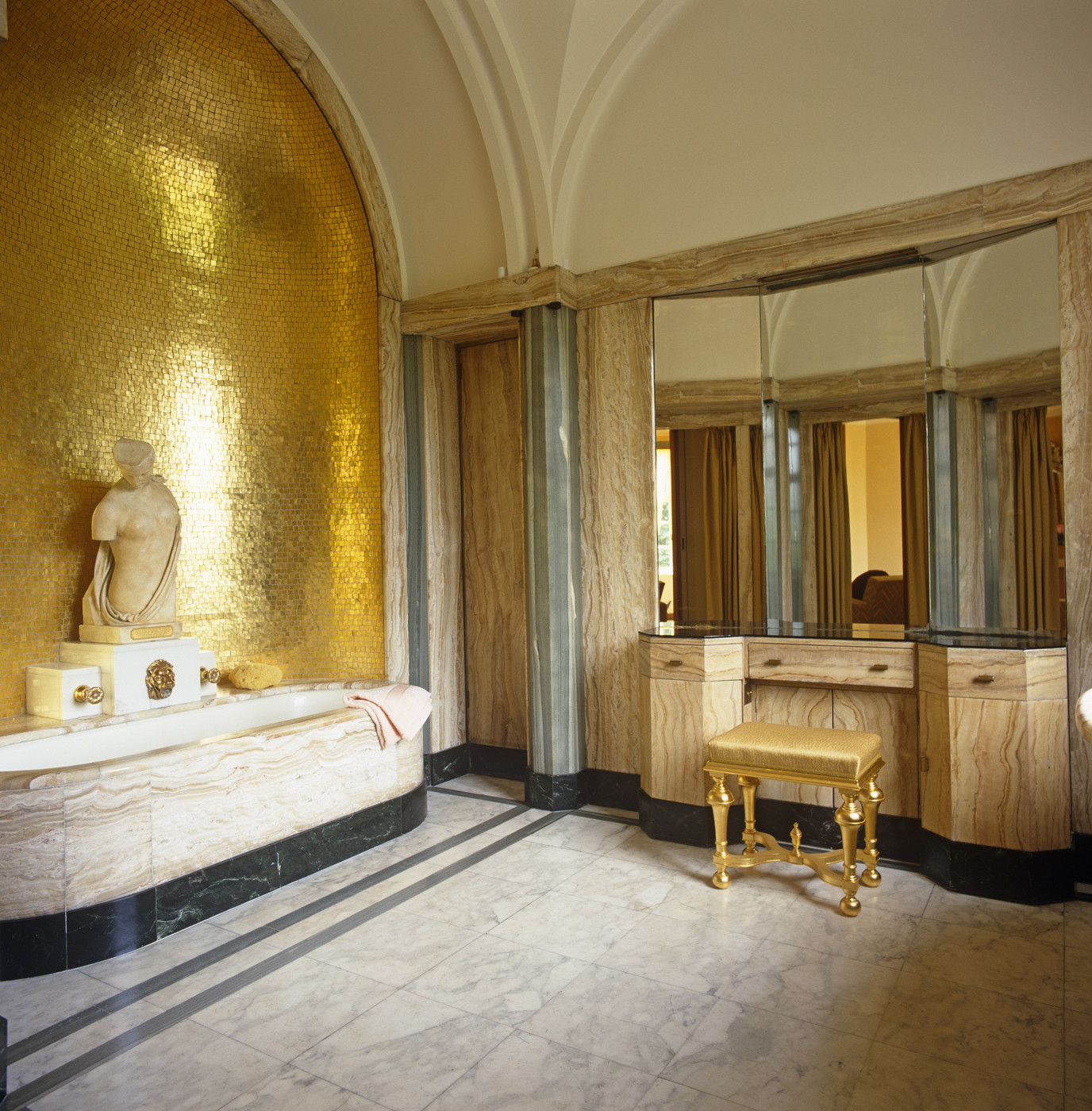 Bathroom vanity with a gold stool