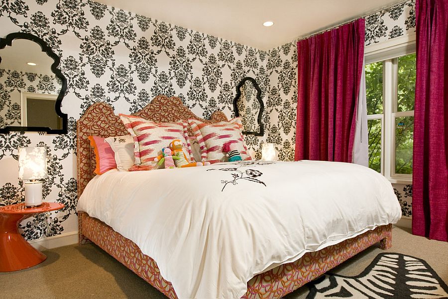 Black and white wallpaper and red drapes for the bright bedroom