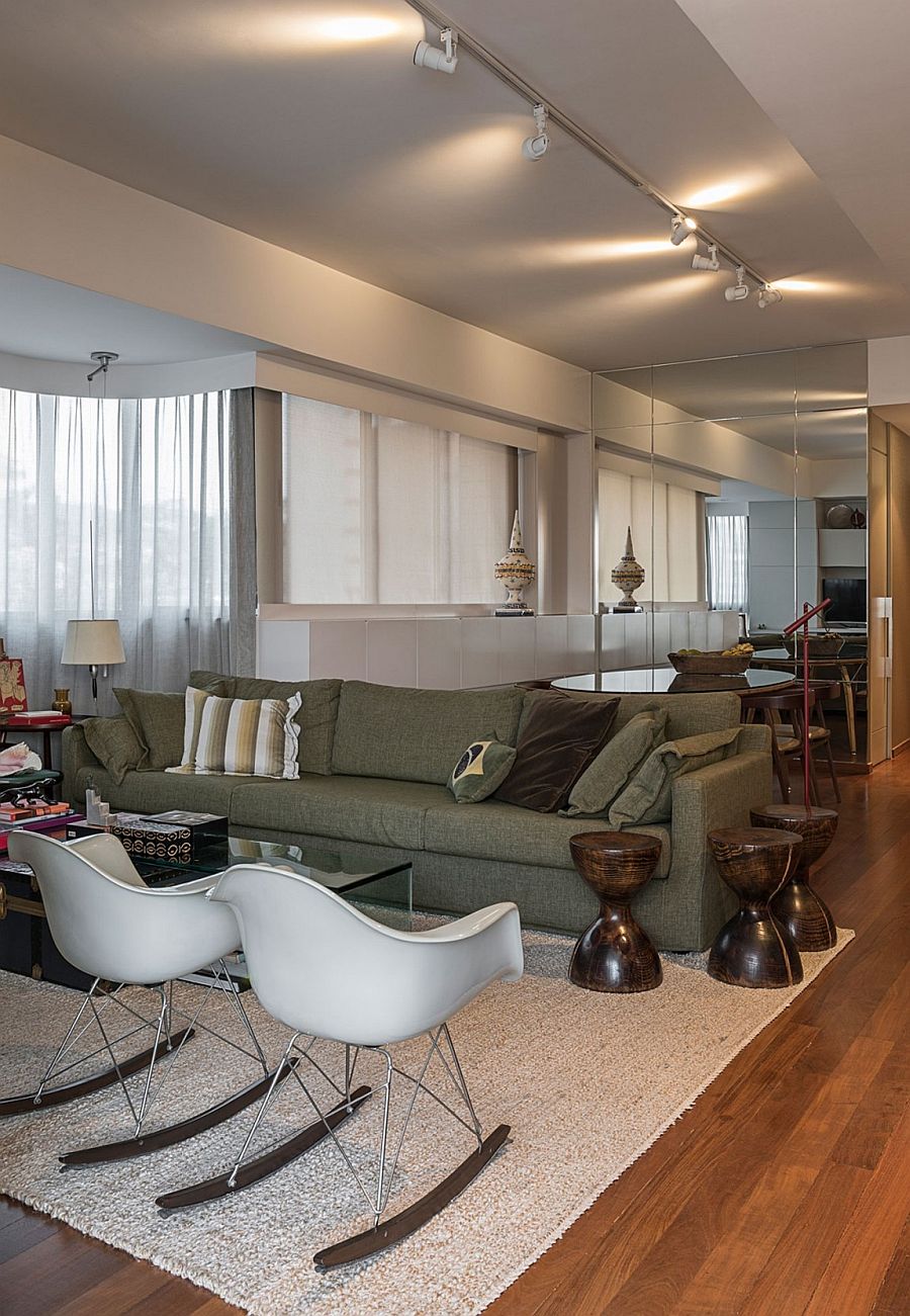 Classic Eames rockers, fun side tables and a plush couch sit in the new living area