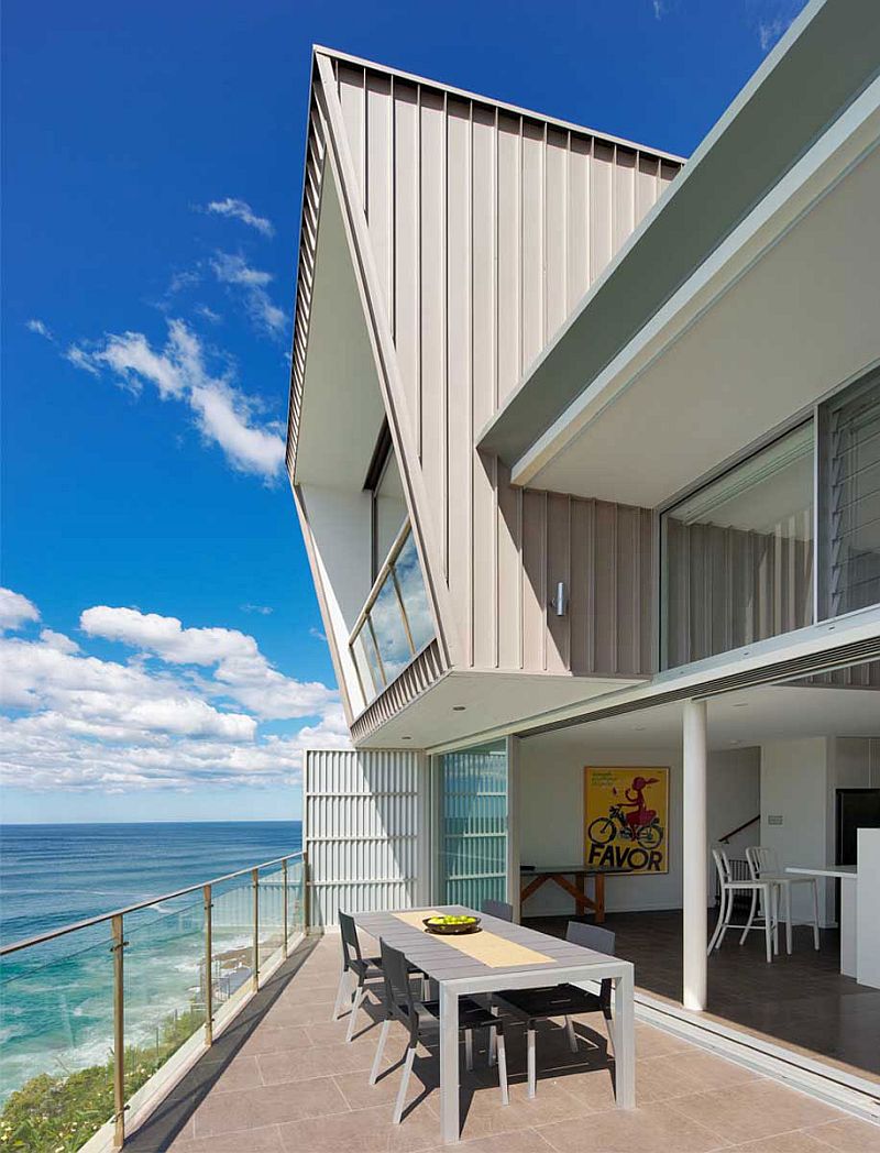 Contemporary beach residence with a balcony that overlooks the ocean