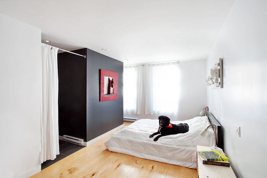 Contemporary bedroom in white with a black accent feature