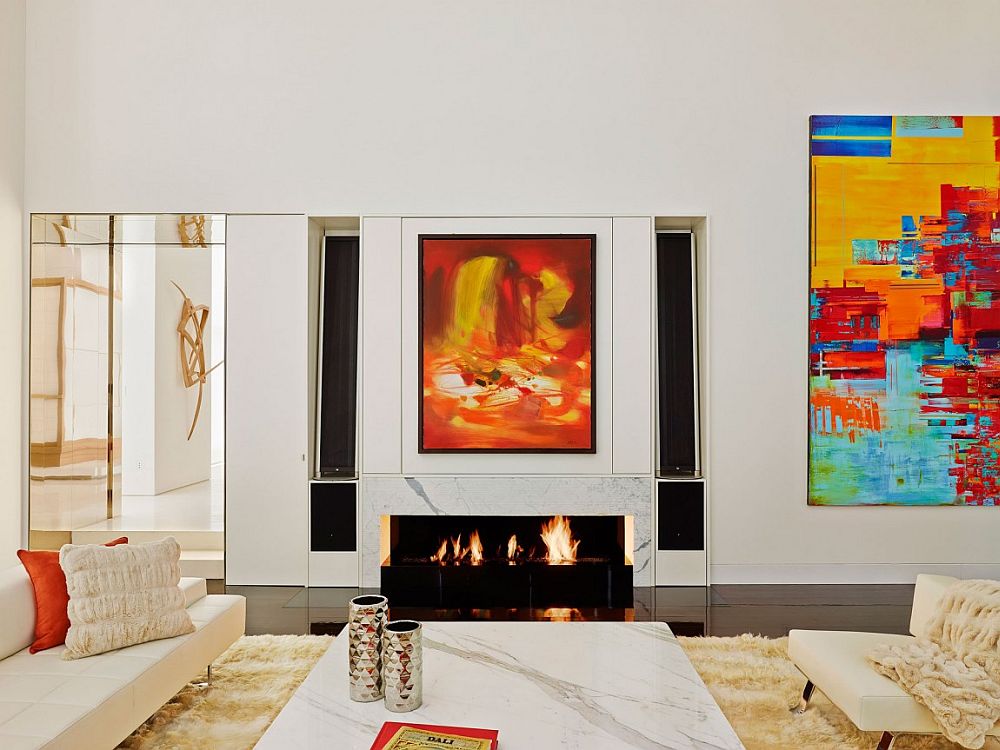 Contemporary minimal interior of NYC apartment with marble fireplace and colorful wall art