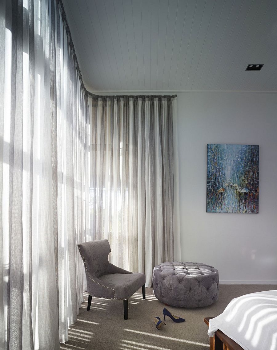 Cozy corner sitting space in the bedroom with chair and ottoman in gray