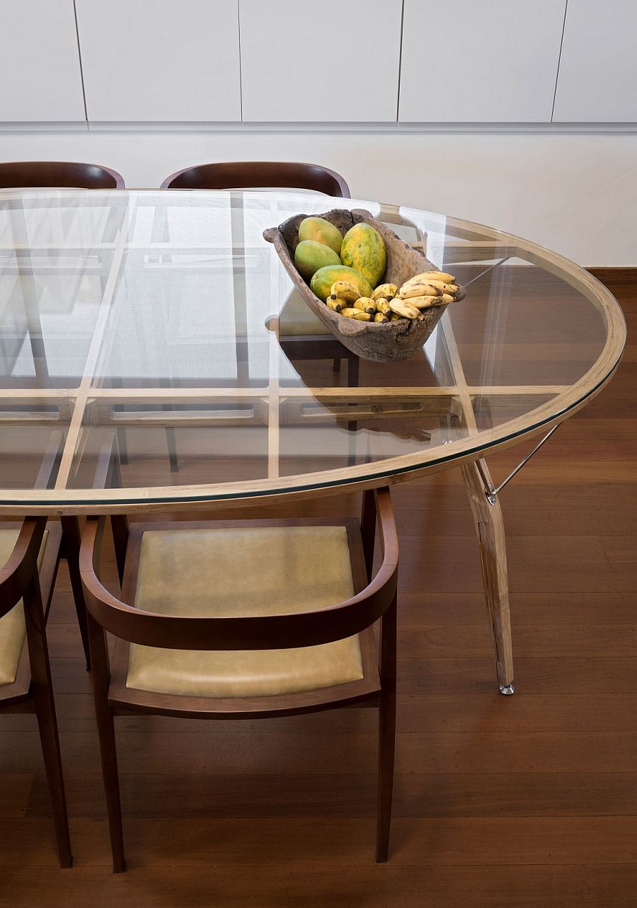 Custom dining table from the 50s sits in the modern Brazilian penthouse