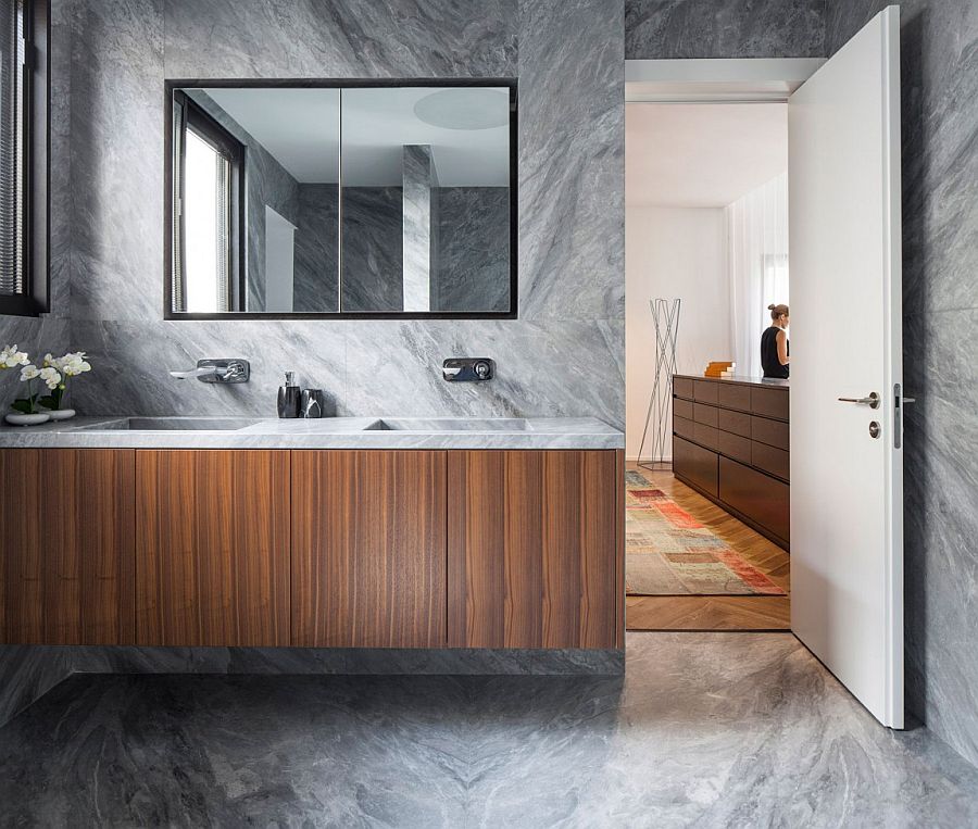 Custom floating wooden vanity with stone countertop