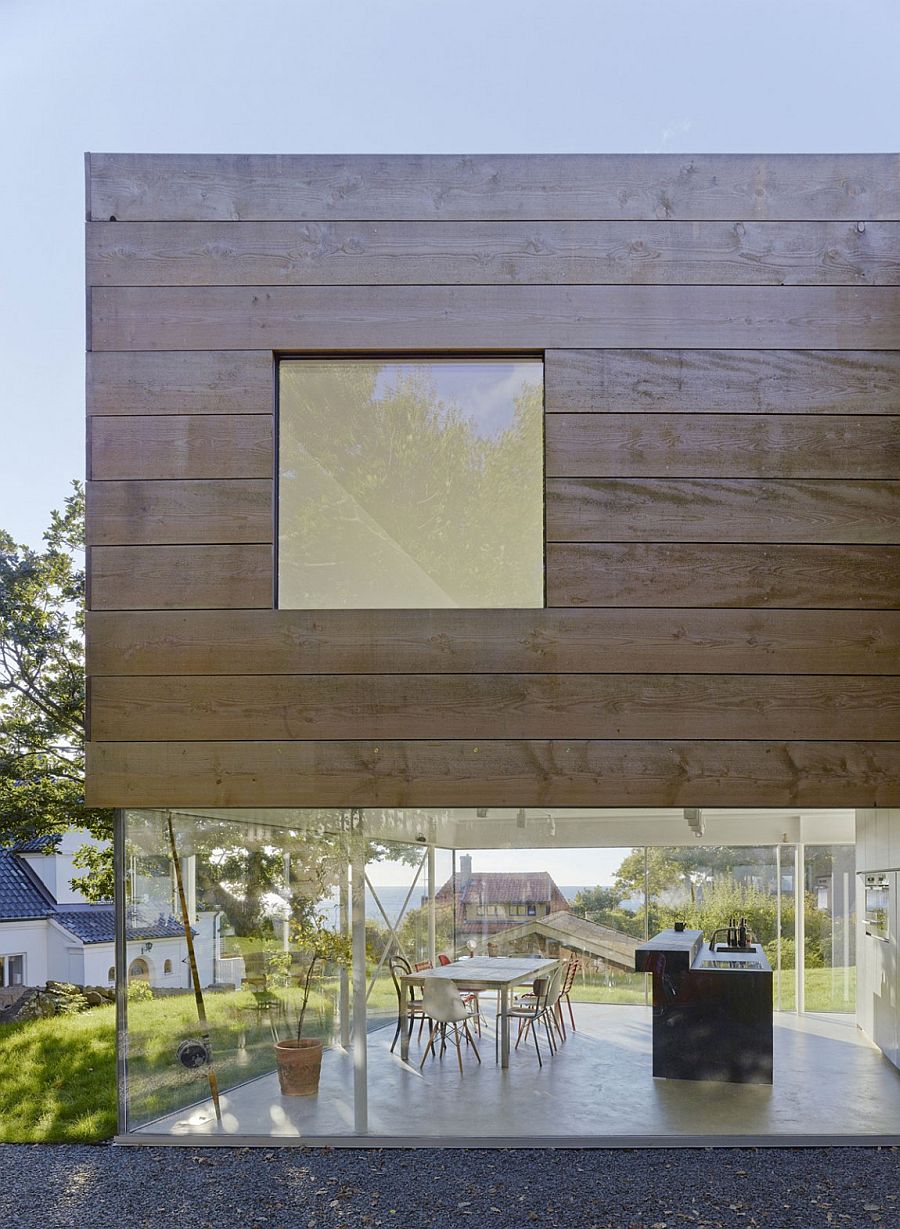 Dining area and kitchen with glass wall at Molle by the Sea