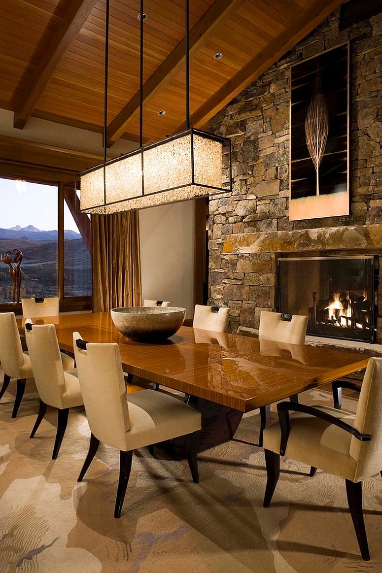 Dining room with stone wall and cozy fireplace