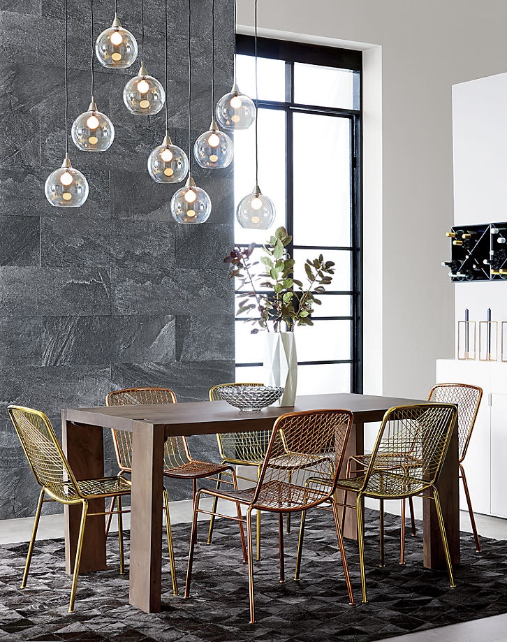 Dining table with mixed metal chairs from CB2