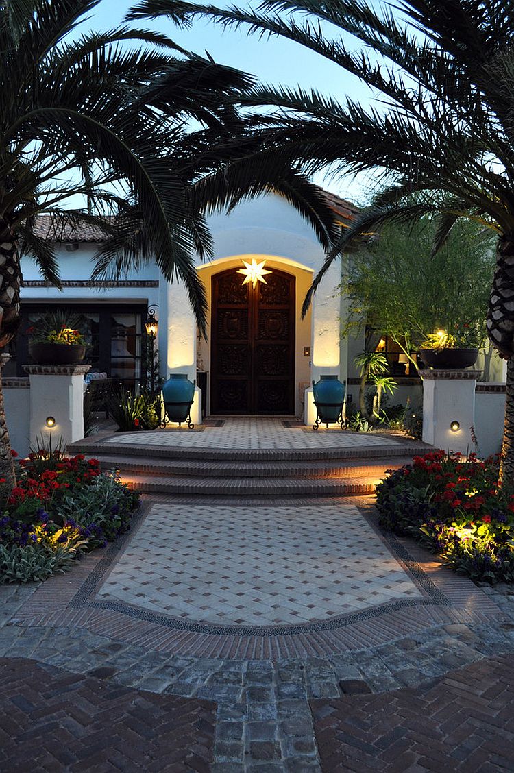 Entryway with arched date palms is the perfect way to lead into a Mediterranean home [Design: Exteriors By Chad Robert]