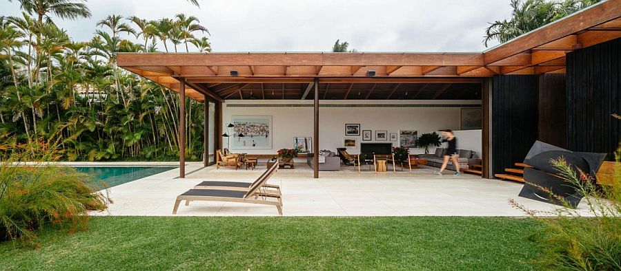 Expansive yard and pool area of Brazilian home defined by its half buried design