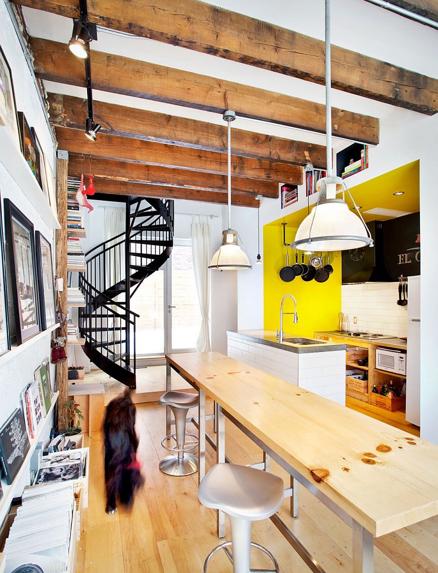 Exposed ceiling beams, spiral staircase and decor give the interior an industrial touch